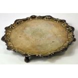 A George III hallmarked silver salver with piecrust rim and bearing central etched crest,
