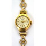 A ladies' 9ct gold wristwatch, the dial set with Arabic numerals and gilt batons on 9ct gold strap.