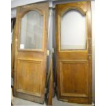 Two oak doors with arched opaque glass top over lower panel with some original door furniture,