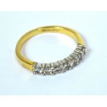 An 18ct gold half eternity ring with seven small white diamonds, size K, 2.9g.