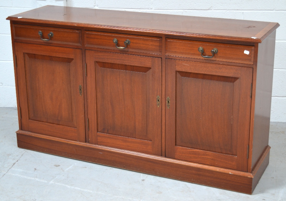 A mid 20th century mahogany sideboard with inlay, three drawers over three cupboard doors,