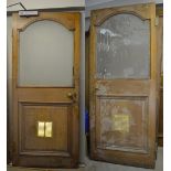 Two oak doors with arched opaque glass top over lower panel with some original door furniture,