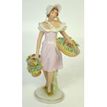 A Royal Dux figurine of a flower seller, pink triangle mark to the base,