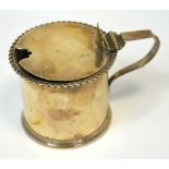 An Edwardian hallmarked silver drum mustard with scrolling shell decorated thumb piece,