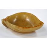 A Chinese carved russet included jade shallow bowl modelled as a leaf, length 7.5cm.