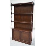 A large hardwood display unit, three shelves above twin door cupboard section, width 114cm.