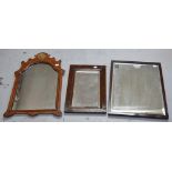 A 19th century walnut mirror with arched and carved top and a shell motif to the centre,