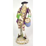 An early 20th century Continental porcelain figurine of a drummer boy with blue marks to the base,