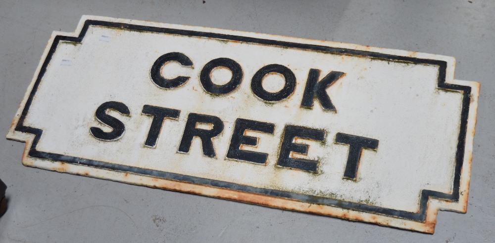 A cast iron street sign 'Cook Street', length 84cm.