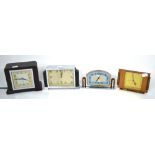 Four vintage Art Deco clocks to include a Smiths clock with a brown Art Deco plastic frame and two