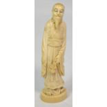 A Japanese Meiji period carved ivory okimono depicting a bearded gentleman holding flowers in his