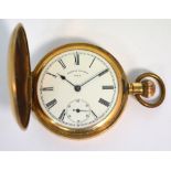 An early 20th century gold plated crown wind full hunter pocket watch with white enamel dial set