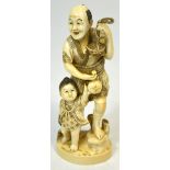 A Japanese Meiji period carved ivory okimono of a gentleman holding a tortoise in his left hand