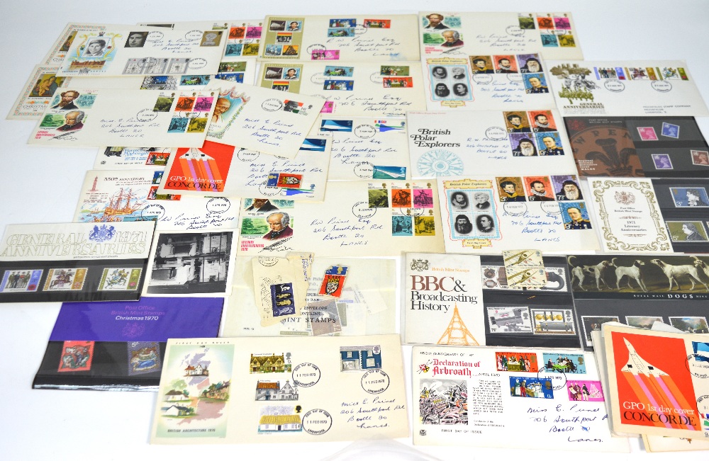 A quantity of stamps, mainly first day covers and a small collection of commemorative coins.