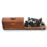 An oak cased Singer EA245228 sewing machine.