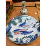 A large 20th century Japanese charger decorated with koi, peonies and prunus,