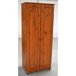 A modern slim two door pine wardrobe, width 73cm.