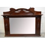 A mahogany over mantel mirror with rectangular bevelled plate, width 132cm.