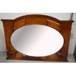 A mahogany over mantel mirror with central oval bevelled plate, width 122cm.