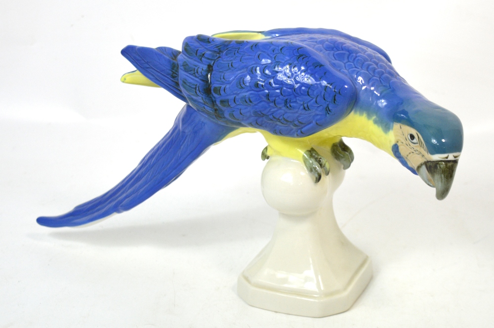 A Royal Dux figure of a parrot perched on a white glazed stand,