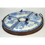 A early 19th century English blue and white willow pattern supper set comprising four shaped lidded