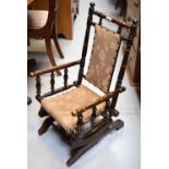 An Edwardian stained beech child's rocking chair.