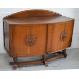 A c1950s oak bow-fronted sideboard, four cupboard doors on a curving shaped support, approx 148cm.