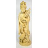 A Japanese Meiji period carved ivory okimono depicting a woman holding a fan in her left hand and