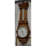 A large heavily carved oak aneroid wall barometer, height 110cm.