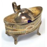 A George V hallmarked silver oval lidded mustard with scrolling thumb piece,