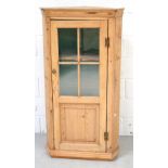 A late 19th century pine flat fronted hanging corner cupboard,