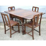 An oak table on barleytwist supports, width approx 153cm and a set of four chairs (5).