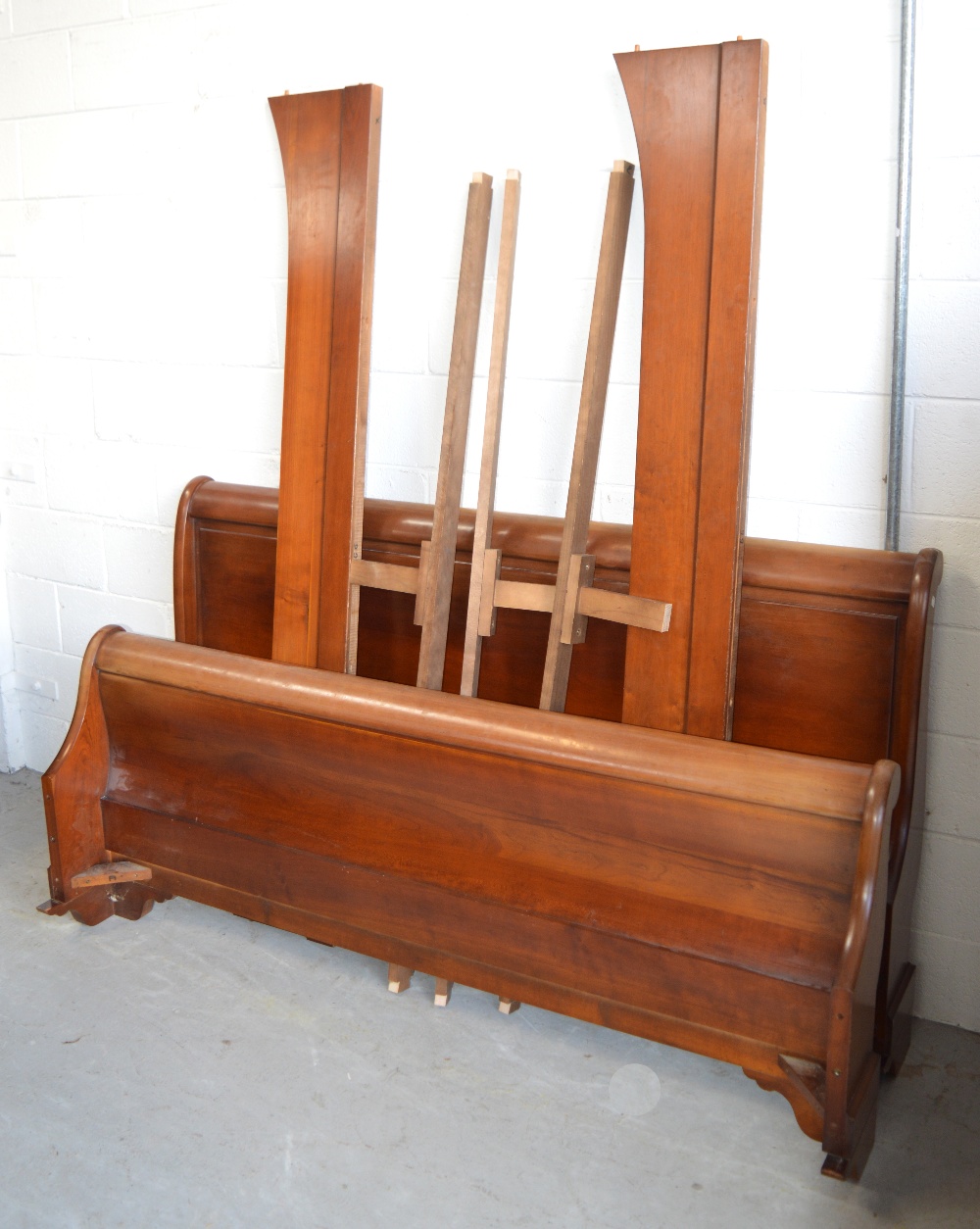 A reproduction shaped double bed, width 170cm.