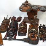 A quantity of decorative tribal masks and a similar hardwood stool fashioned as an elephant.