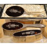 A cased Victorian hallmarked silver and tortoiseshell dressing table set to include two brushes,