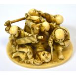 A Japanese Meiji period carved ivory okimono depicting six male figures fighting,