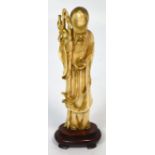 A Japanese Meiji period carved ivory and gilt heightened okimono modelled as an Immortal holding a