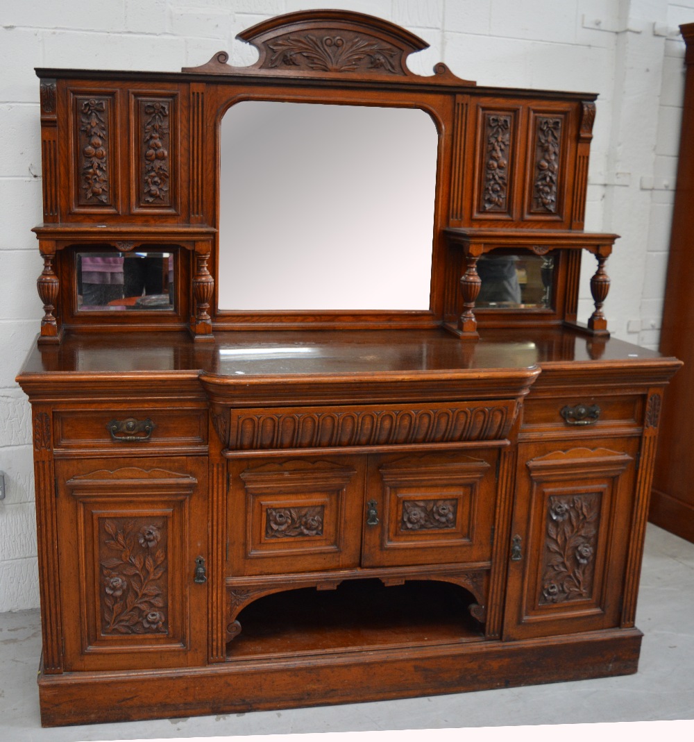 An Edwardian mirror back sideboard with shelf to either side over two drawers above two cupboard