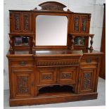 An Edwardian mirror back sideboard with shelf to either side over two drawers above two cupboard