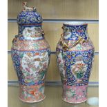 A pair of late 19th early 20th century Chinese famille rose pattern vases and covers with