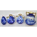 A pair of Royal Doulton flow blue and gilt heightened vases, height of both 15cm,