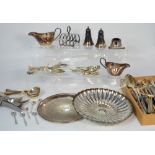 A quantity of silver plated items to include flatware, a pair of sauce boats, a toast rack etc.