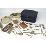 A vintage vanity case containing a small quantity of plated ware to include an Art Deco style brush