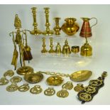 A quantity of brass ware to include a wall plaque, various pots, a companion set, candlesticks,