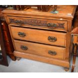 An early Victorian oak three drawer chest of drawers with acanthus leaf carving to the top,