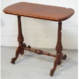 A Victorian mahogany occasional table, the rounded rectangular top above twin turned end supports,
