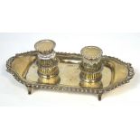 A George V hallmarked silver inkstand with twin silver topped circular glass inkwells (one damaged