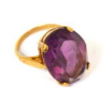 A 9ct gold ring set with a large amethyst coloured stone, size L, approx 5.9g.