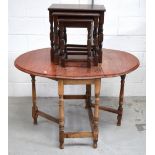 A nest of tables and an oak dropleaf dining table on turned legs and stretchers,