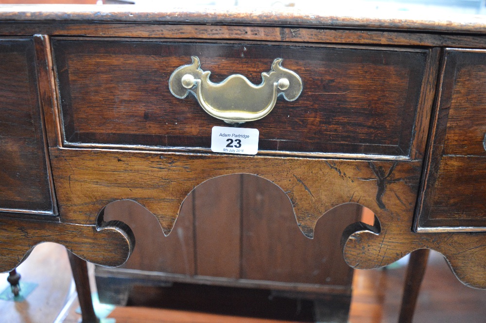 An 18th century oak lowboy with three drawers and shaped apron on pad feet, width 83cm. - Image 3 of 4
